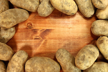 Image showing Russet Potatoes on a Wooden Background