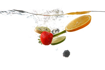 Image showing Fruits Falling Into Splashing Clear Water