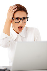 Image showing Woman looking at her laptop in horror