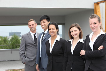 Image showing Confident business team standing together outdoors