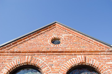 Image showing round window arch retro brick house roof blue sky 