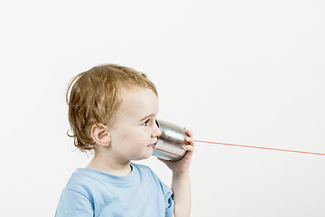 Image showing young child with tin can phone