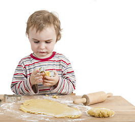 Image showing young child with rolling pin and dough