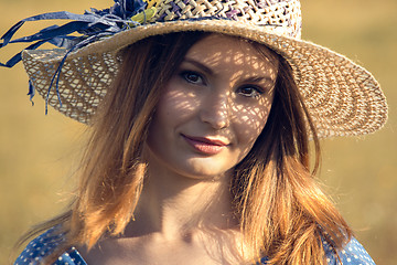 Image showing Girl with a straw hat