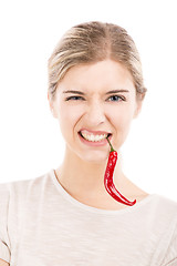 Image showing Woman with a silly face holding a red chilli pepper