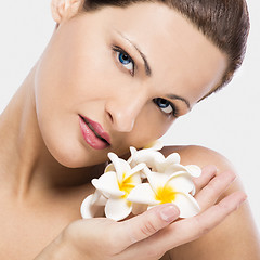 Image showing Beautiful woman holding flowers