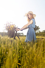 Image showing Beautiful woman with her bicycle