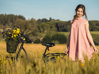 Image showing Beautiful woman with her bicycle