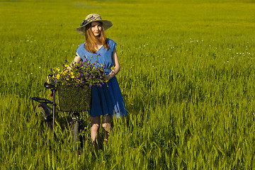 Image showing Beautiful woman with her bicycle