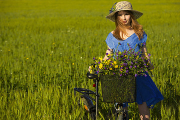 Image showing Beautiful woman with her bicycle