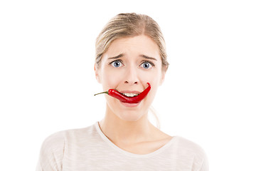 Image showing Woman with a silly face holding a red chilli pepper