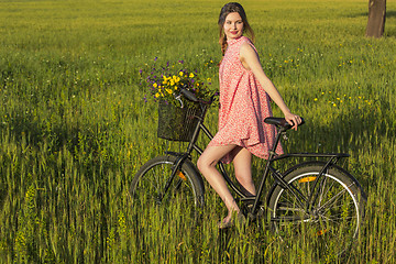 Image showing Beautiful woman with her bicycle