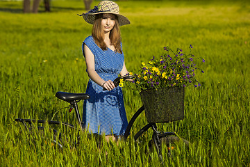 Image showing Beautiful woman with her bicycle