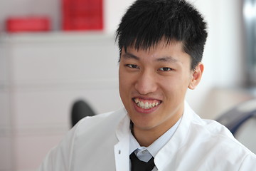 Image showing Smiling Asian man in a lab coat