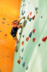 Image showing little girl climbing up the wall