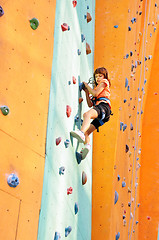 Image showing child climbing up the wall