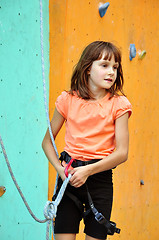 Image showing child with climbing equipment against the training wall