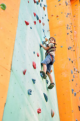 Image showing child climbing up the wall