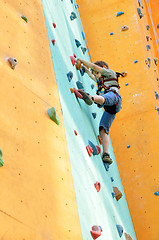 Image showing small child climbing up the wall