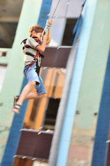 Image showing child sliding down in the urban scene