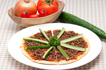 Image showing Turkish beef pizza with cucumber on top