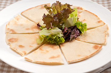 Image showing garlic pita bread pizza with salad on top