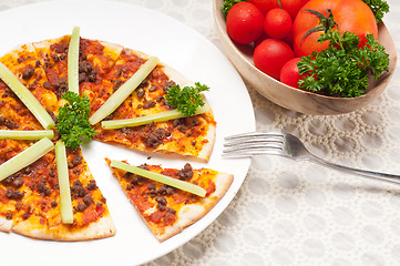 Image showing Turkish beef pizza with cucumber on top