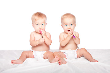 Image showing Cute twins babies with spoons