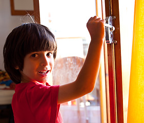 Image showing boy opens the door of a new home