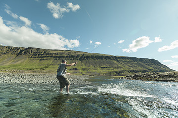 Image showing Flyfisherman casting the fly