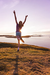 Image showing Teenage girl dancing in the sunset