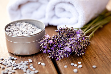 Image showing fresh lavender white towel and bath salt on wooden background
