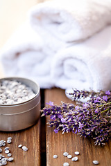 Image showing fresh lavender white towel and bath salt on wooden background