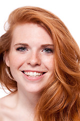 Image showing beautiful young smiling woman with red hair and freckles isolated