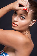 Image showing beautiful young woman with orange lipstick and brown eyes 