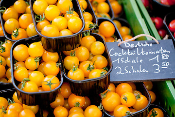 Image showing fresh tasty yellow cherry tomatoes macro closeup on market