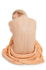 Image showing young blonde woman sitting on towel naked back isolated 