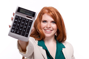 Image showing attractive smiling redhead business woman with calculator isolated