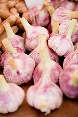 Image showing group of purple white garlic in basket macro