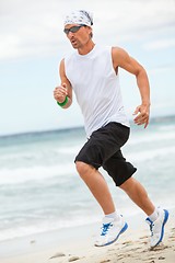 Image showing man is jogging on the beach summertime sport fitness