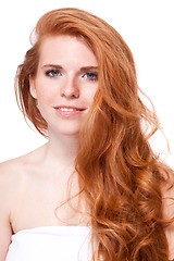 Image showing beautiful young smiling woman with red hair and freckles isolated