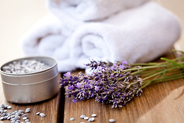 Image showing fresh lavender white towel and bath salt on wooden background