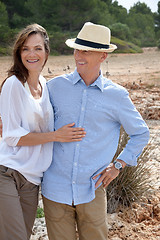 Image showing happy adult couple in summertime on beach 