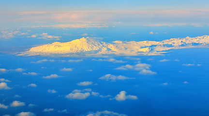 Image showing aerial view of mountains and clouds on top