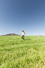 Image showing Teenage girl running in meadow