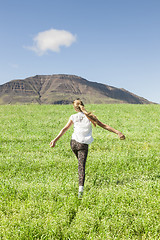 Image showing Young girl running in the field