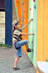 Image showing child climbing up the wall