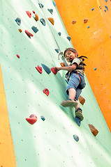 Image showing child climbing up the wall