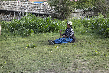 Image showing  Tibetan woman and prayer wheel