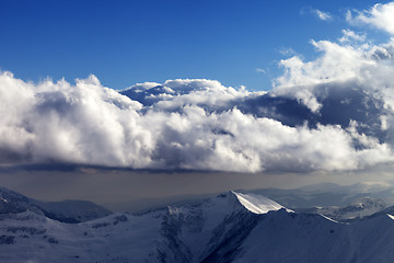 Image showing Winter mountains in evening and sunlight clouds